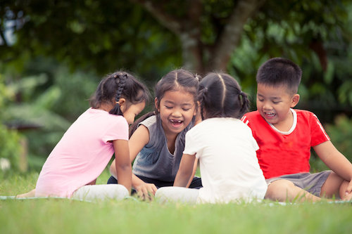 Happy children playing and having fun together in outdoor in summer time