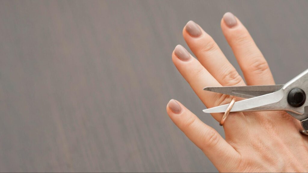 Woman cutting ring with scissors