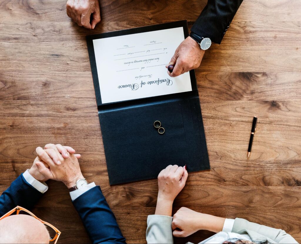 A mediator with two clients stamping divorce paperwork