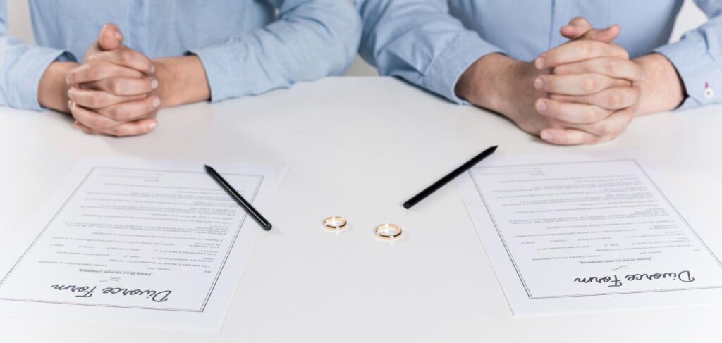Two people with divorce paperwork in front of them