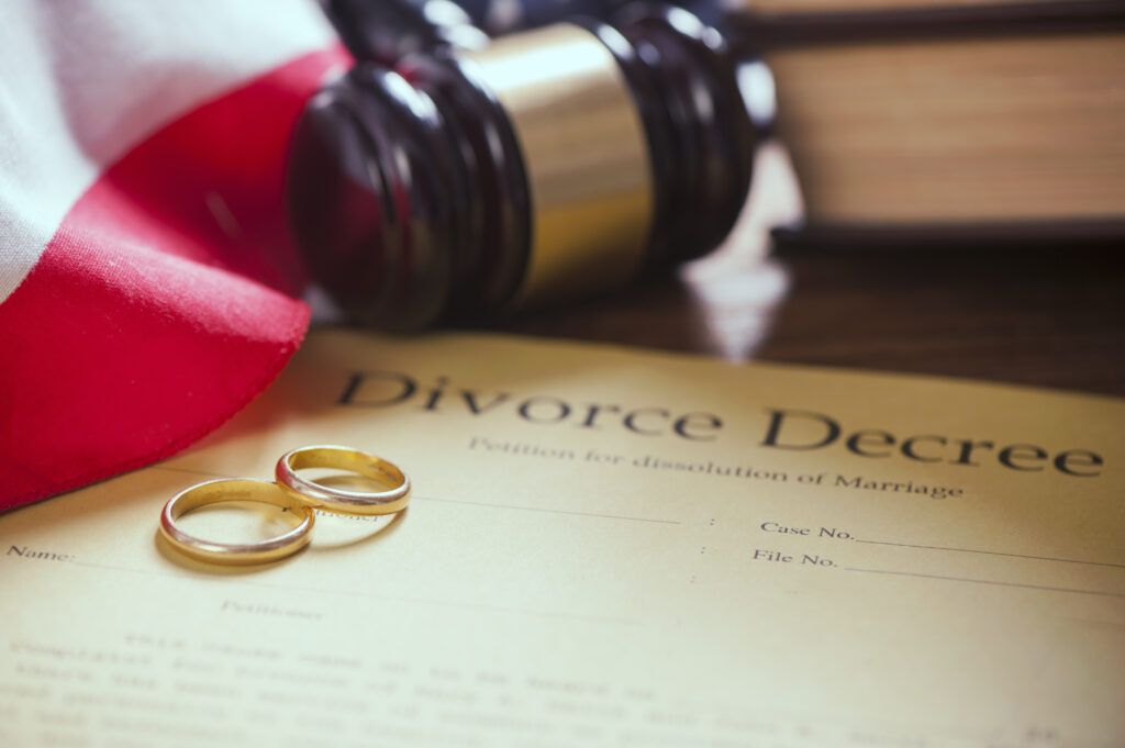 Close-up of wedding rings on wooden table with American flag